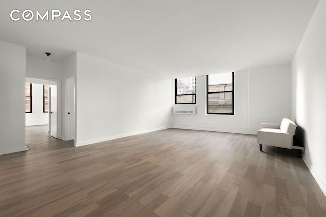 unfurnished room featuring wood finished floors and baseboards