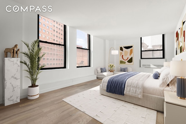 bedroom with baseboards and wood finished floors