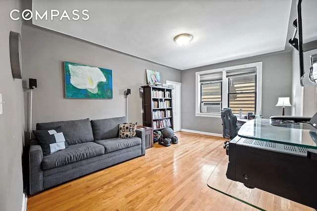 office space featuring cooling unit, baseboards, and hardwood / wood-style flooring