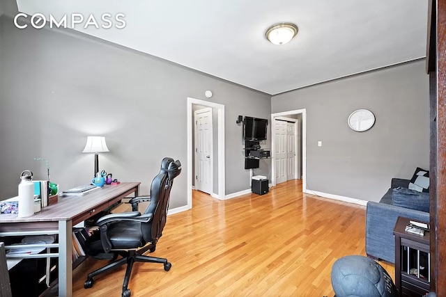 office featuring baseboards and wood finished floors