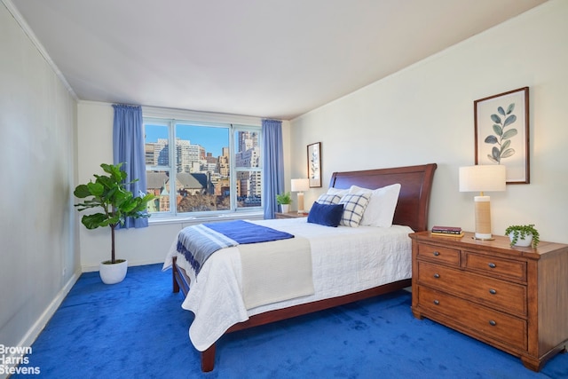 bedroom with a city view, baseboards, crown molding, and carpet