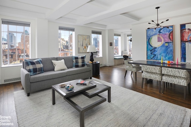 living room featuring hardwood / wood-style flooring, plenty of natural light, and coffered ceiling