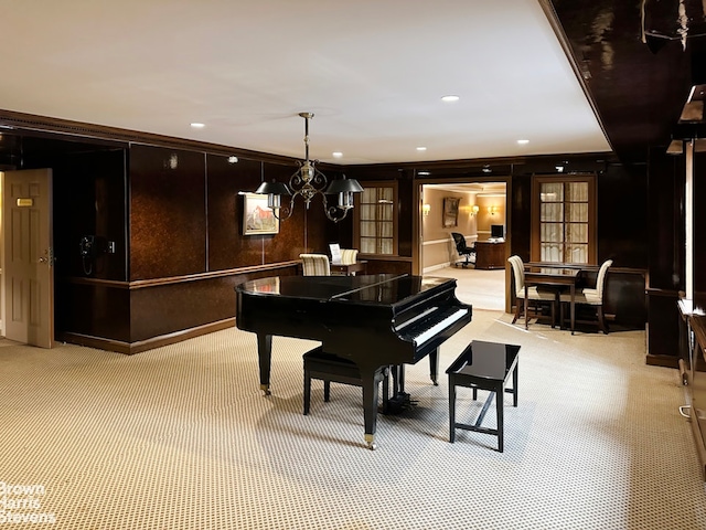 living area with recessed lighting, light colored carpet, and an inviting chandelier