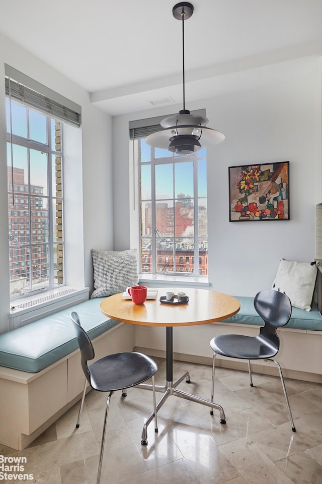 dining space featuring a view of city, a wealth of natural light, and breakfast area