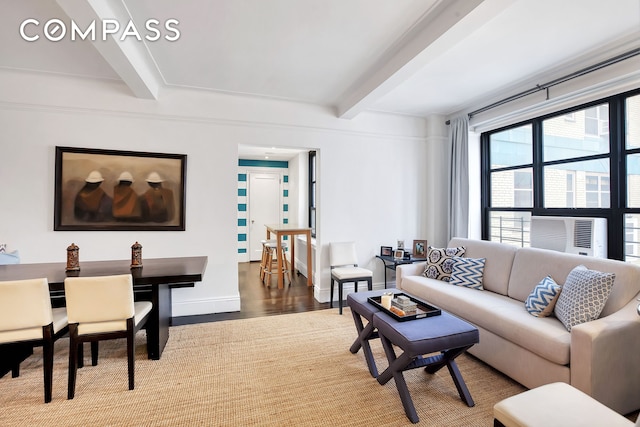 living area with beamed ceiling, cooling unit, baseboards, and wood finished floors