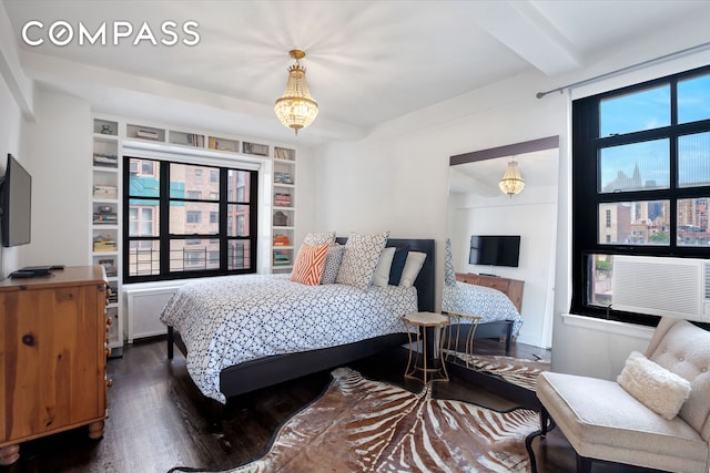 bedroom with radiator, beamed ceiling, multiple windows, and dark wood-style floors