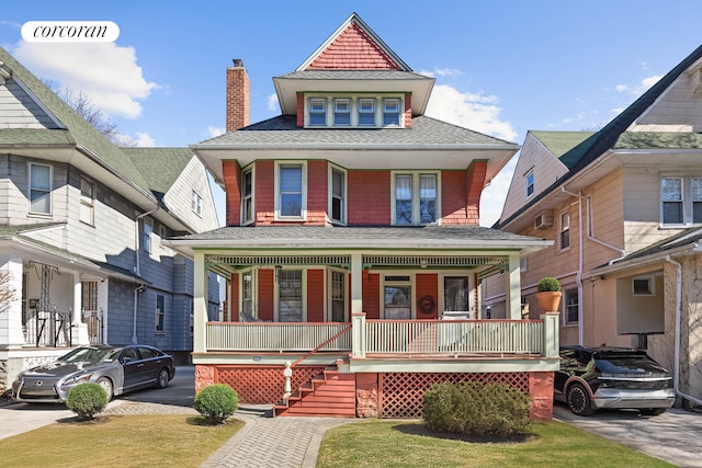 view of front of property with covered porch, driveway, and a shingled roof