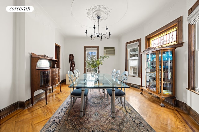 dining area with an inviting chandelier, visible vents, baseboards, and a wall mounted air conditioner