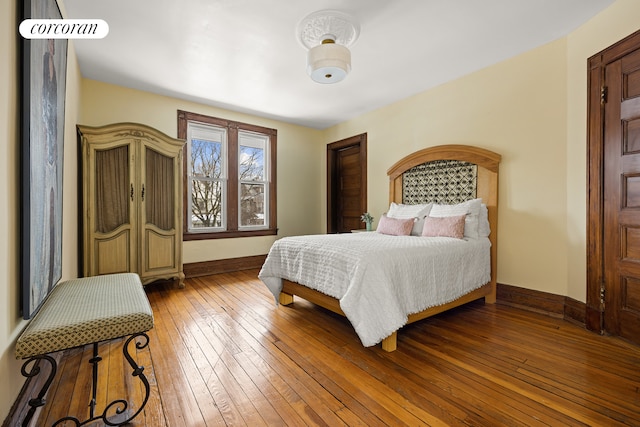 bedroom featuring baseboards and wood-type flooring