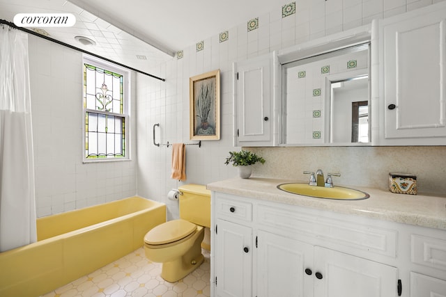 full bathroom with shower / bath combo with shower curtain, toilet, tasteful backsplash, tile walls, and vanity