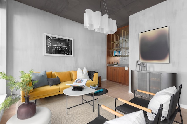 living room featuring indoor wet bar and light wood-type flooring