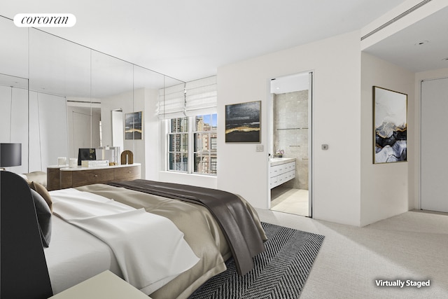 bedroom featuring carpet and ensuite bathroom