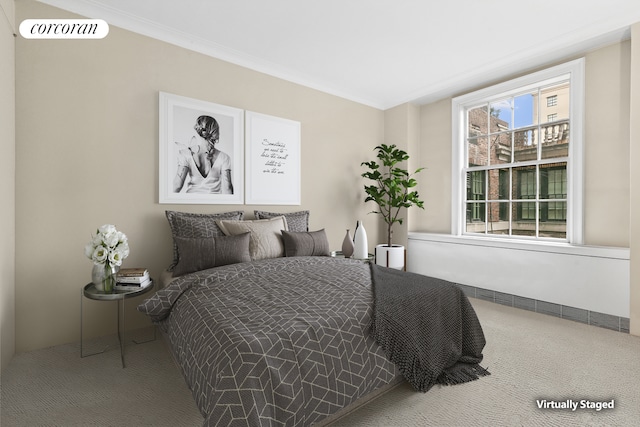 carpeted bedroom featuring crown molding