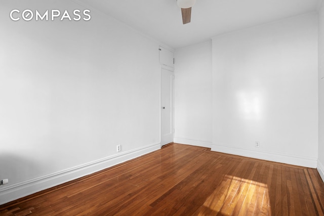 unfurnished room with baseboards, wood-type flooring, and a ceiling fan