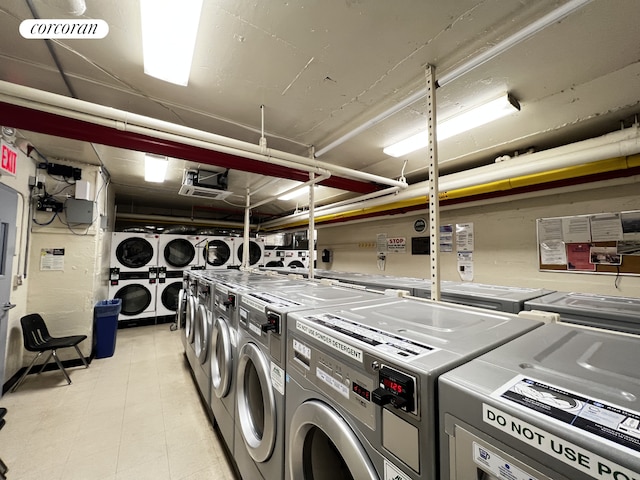 shared laundry area with washer and dryer, a garage, stacked washer and clothes dryer, and visible vents