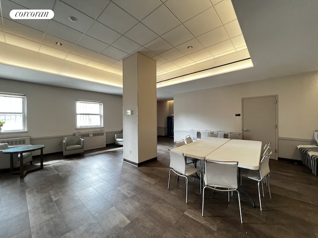 dining area featuring visible vents, a tray ceiling, radiator heating unit, baseboards, and a paneled ceiling