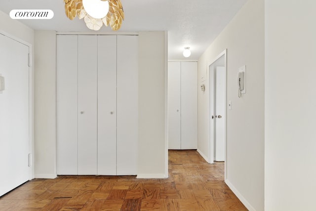 hallway with visible vents and baseboards