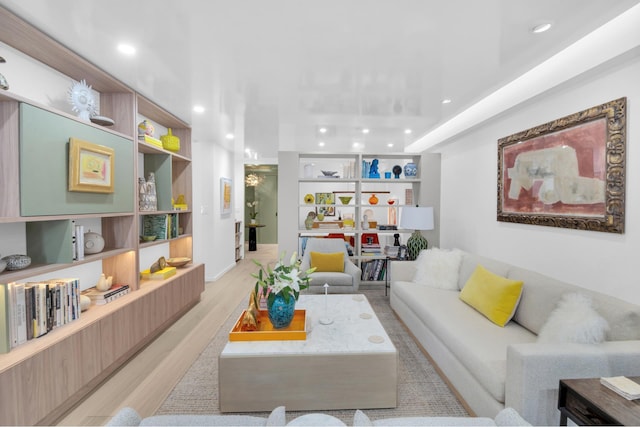 living room featuring recessed lighting, light wood-style floors, and built in features