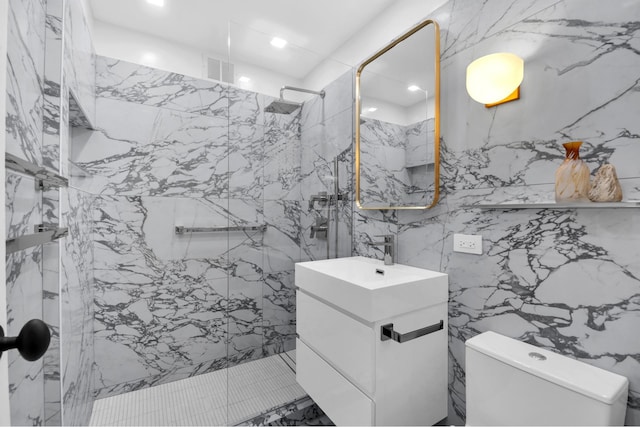 full bathroom featuring a marble finish shower, visible vents, toilet, vanity, and stone wall