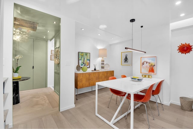 dining room featuring recessed lighting, light wood-style flooring, and baseboards