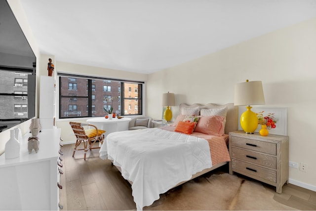 bedroom with light wood-style floors and baseboards