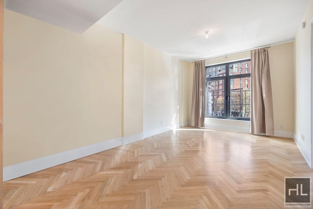 unfurnished room featuring baseboards