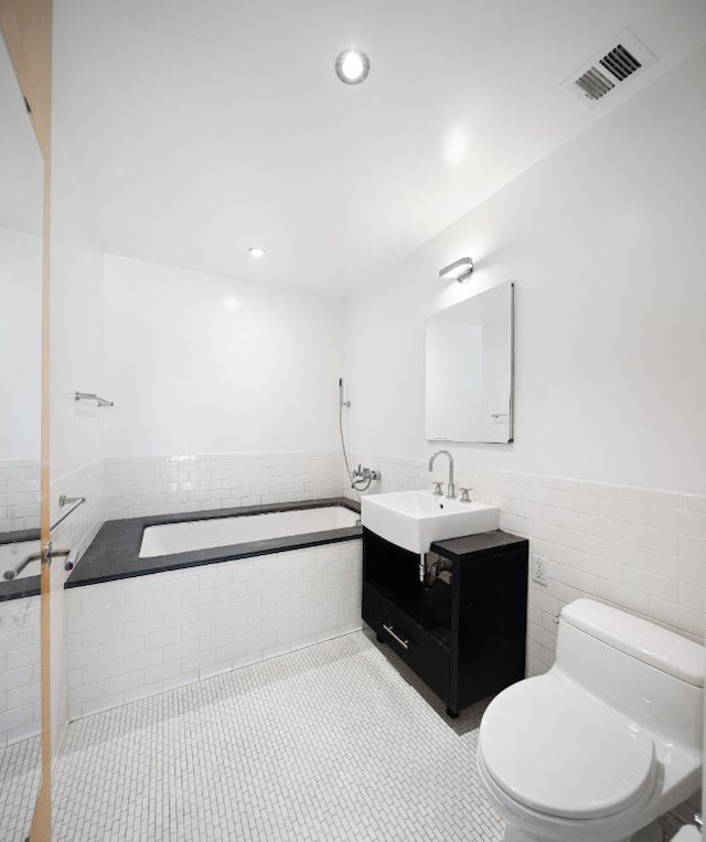 full bathroom featuring visible vents, toilet, a garden tub, tile patterned floors, and vanity