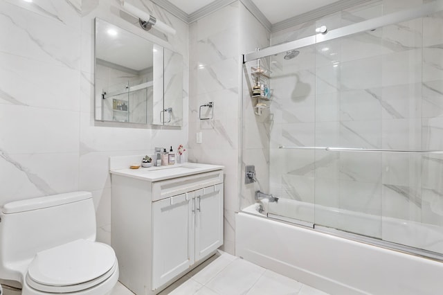 bathroom with toilet, ornamental molding, shower / bath combination with glass door, tile walls, and vanity