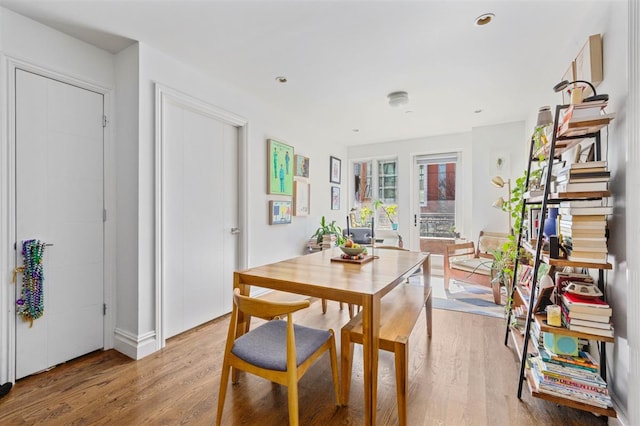 dining area with recessed lighting and light wood-style floors