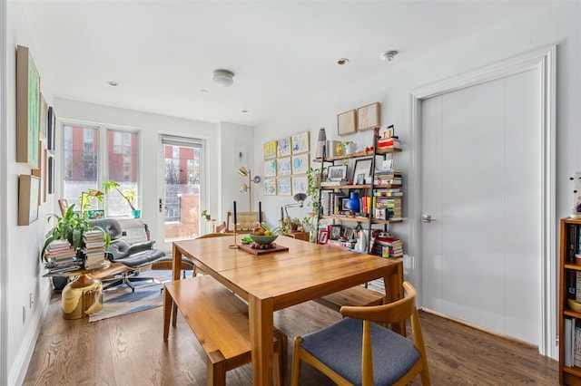 dining room with baseboards and wood finished floors