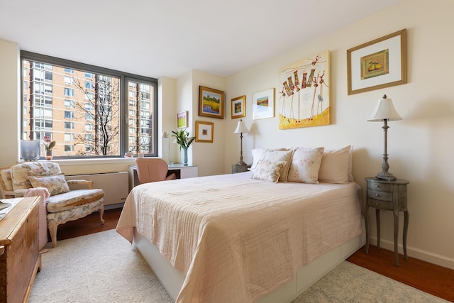 bedroom featuring wood finished floors and baseboards