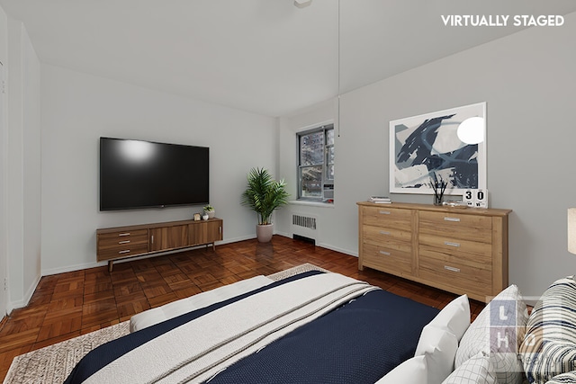 bedroom featuring baseboards and radiator heating unit