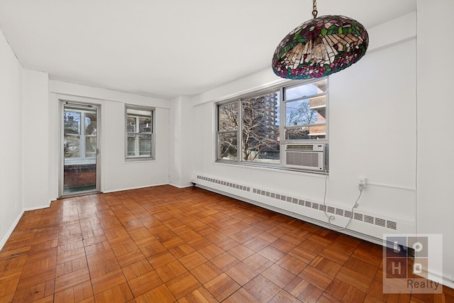 empty room with a wealth of natural light, cooling unit, and a baseboard radiator