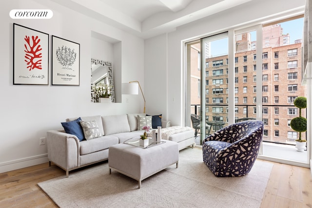 living area with visible vents, wood finished floors, and baseboards