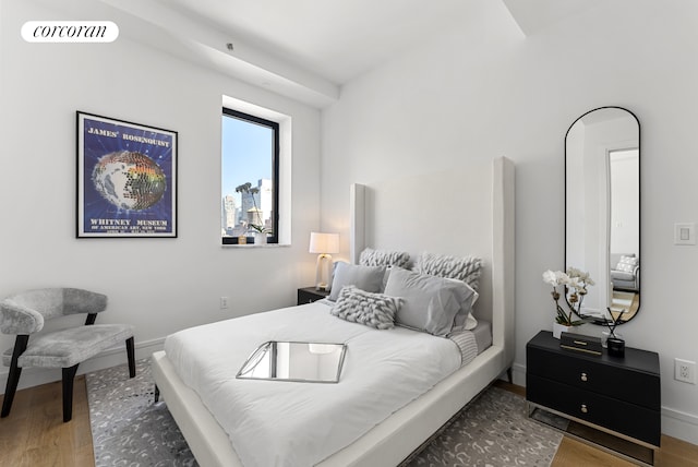 bedroom with wood finished floors and baseboards