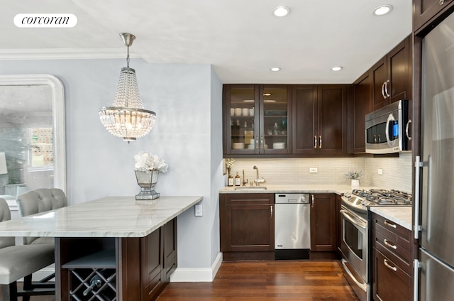 bar featuring a sink, visible vents, tasteful backsplash, and appliances with stainless steel finishes