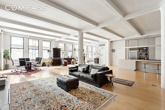 living room featuring beam ceiling, light wood-style floors, and coffered ceiling