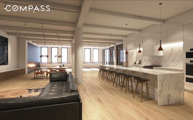 living room with beam ceiling, light wood-style flooring, and track lighting