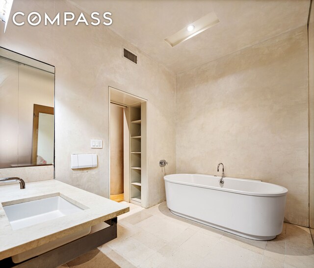 15 W 24th St Unit 3, New York City, NY 10010 - bathroom featuring a freestanding bath, a sink, built in shelves, and visible vents