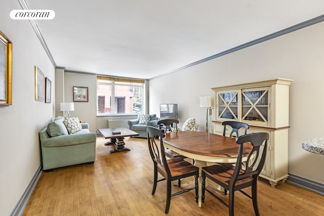 dining space featuring crown molding, baseboards, light wood-type flooring, and visible vents