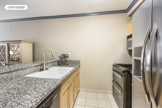 kitchen with light tile patterned floors, light brown cabinets, a sink, stainless steel appliances, and crown molding