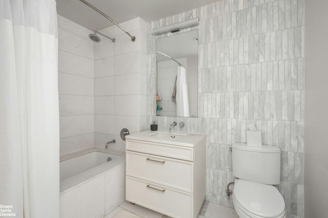 bathroom featuring tiled shower / bath combo, toilet, tile walls, and vanity