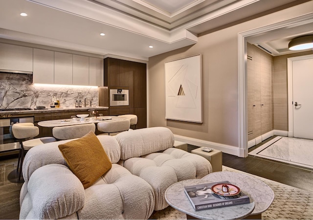 cinema room with baseboards, recessed lighting, ornamental molding, and a tray ceiling