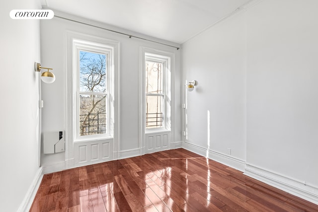 foyer featuring wood finished floors, visible vents, and baseboards