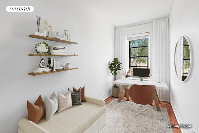 home office featuring wood finished floors and baseboards