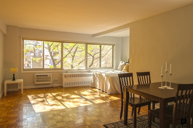 dining room featuring a wealth of natural light, beam ceiling, radiator, and a wall mounted AC