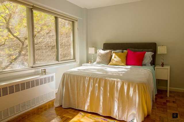 bedroom featuring radiator heating unit and baseboards