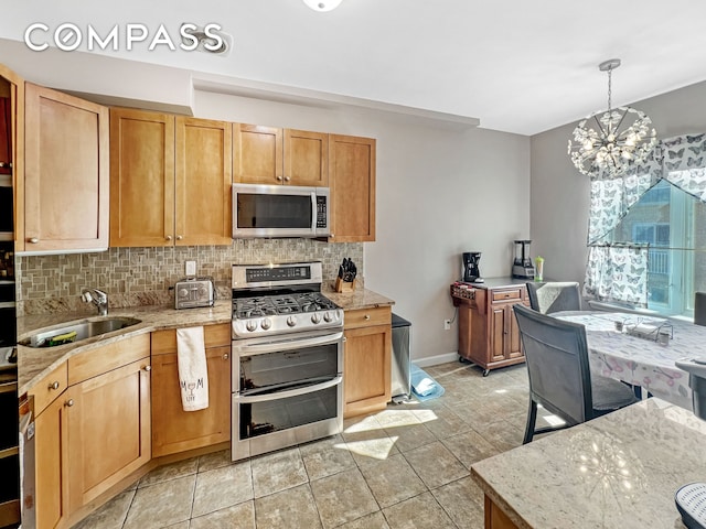 kitchen with tasteful backsplash, a notable chandelier, stainless steel appliances, and a sink