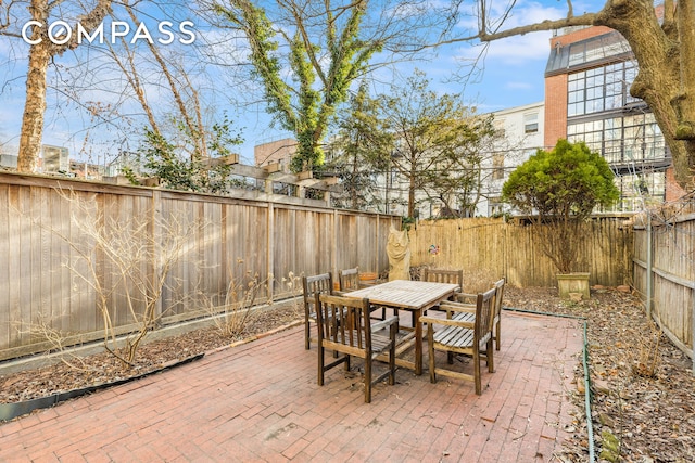 view of patio with outdoor dining area and a fenced backyard