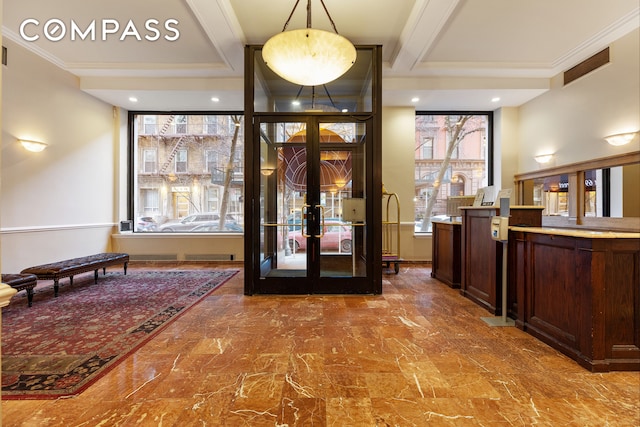 entrance foyer featuring french doors, a wealth of natural light, and ornamental molding